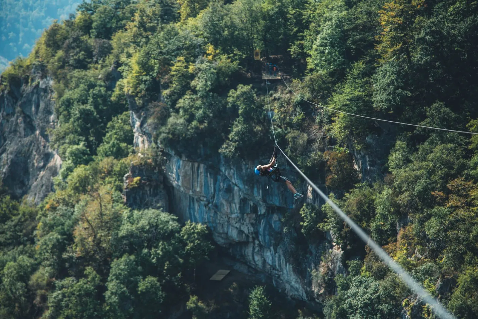 Zipline rider high above the canyon