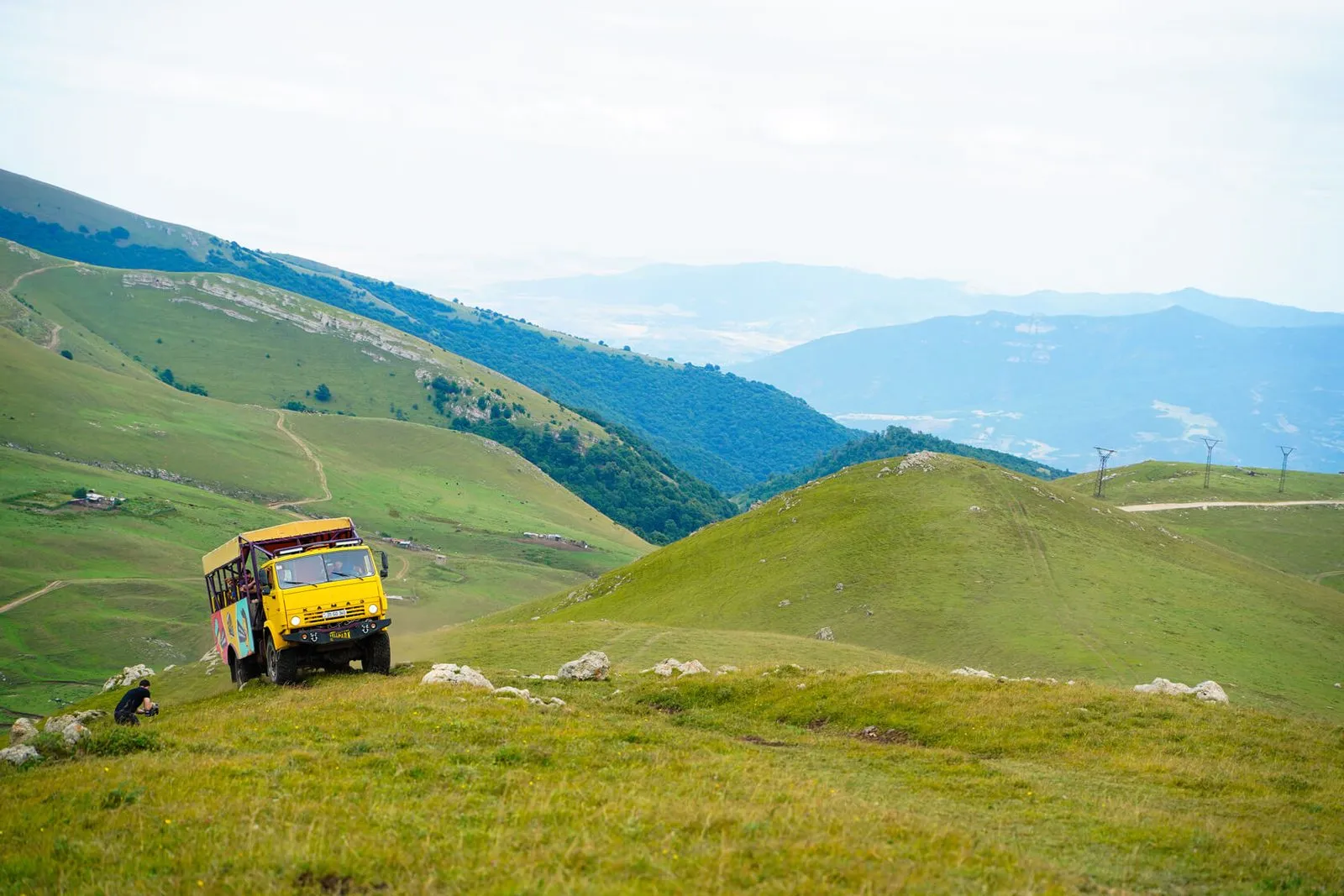 Yellow Yell truck crossing the alpine meadows